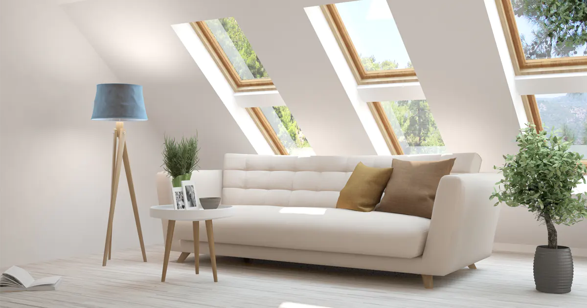 Modern living room with large glass roof and walls, abundant natural daylight and view of trees outside